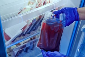 doctor holding a bag of red blood in the blood storage refrigerator in the laboratory